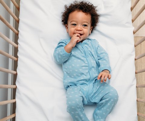 Happy baby in a crib